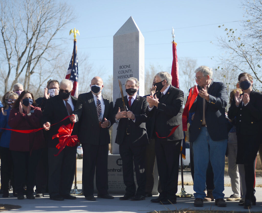 Officials of the state and Boone, Callaway and Cole counties cut a ribbon unveiling the new bicentennial statue